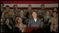 Mrs. Laura Bush addresses American troops Thursday, Oct. 25, 2007, at Ali Al Salem Air Base near Kuwait City. "With your courage and compassion, you show that the United States military is one of the greatest forces for good in the world," Mrs. Bush told the troops. "And I hope you know that we pray. for an end to the violence everywhere so that future generations can grow up in a world at peace -- a world that you shaped." White House photo by Lynden Steele