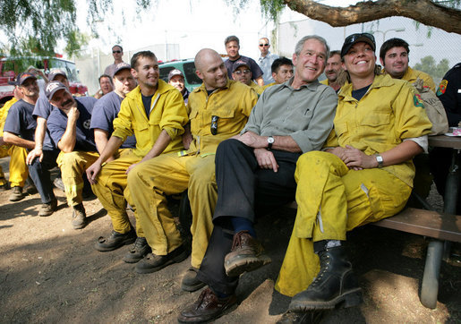 President George W. Bush visits a base camp Thursday, Oct. 25, 2007, for First Responders battling the Southern California wildfires. "I'm telling you, there's a lot of folks that live up in these hills that have their houses because of you," the President told the fire fighters. ". They're not in a position to thank you -- but we are. And so we thank you for helping save lives and save property." White House photo by Eric Draper