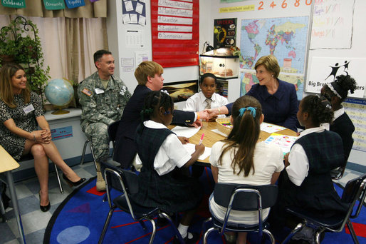 Mrs. Laura Bush shakes hands with student Taylor McIntyre, during her visit with students at the Good Shepherd Nativity Mission School, Thursday, Nov. 1, 2007 in New Orleans, a Helping America's Youth visit with Big Brother and Big Sisters of Southeast Louisiana. Captain Richard T. Douget, second from left, is a Big Brother to Taylor McIntyre. White House photo by Shealah Craighead