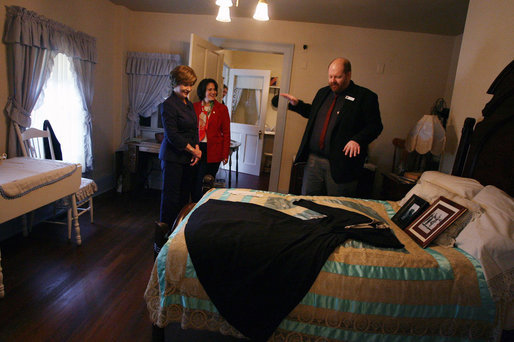 Mrs. Laura Bush, joined by her Chief of Staff Anita McBride, listens to Russell Caldwell, manager of visitor services, as he describes artifacts during a tour of the Margaret Mitchell House and Museum, Thursday, Nov. 1, 2007 in Atlanta, Ga. It was in this house that Mitchell wrote the novel, Gone with the Wind. White House photo by Shealah Craighead