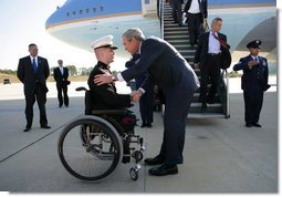 President George W. Bush greets Marine Corps Lt. Andrew Kinard, a 24-year-old from Spartanburg, S.C., after arriving Friday, Nov. 2, 2007, at Columbia Metropolitan Airport in Columbia, S.C. The Marine was wounded in 2006 while serving in Iraq. White House photo by Eric Draper