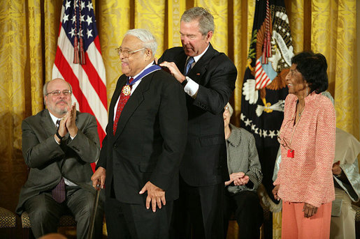 President George W. Bush awards the Presidential Medal of Freedom to civil rights activist Benjamin Hooks as his wife Frances Hooks stands by during a ceremony Monday, Nov. 5, 2007, in the East Room. "The nation best remembers Benjamin Hooks as the leader of the NAACP. For 15 years, Dr. Hooks was a calm yet forceful voice for fairness, opportunity, and personal responsibility. He never tired or faltered in demanding that our nation live up to its founding ideals of liberty and equality," said the President. White House photo by Eric Draper