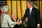President George W. Bush awards the Presidential Medal of Freedom to Liberian President Ellen Johnson Sirleaf during a ceremony Monday, Nov. 5, 2007, in the East Room. "When free elections returned to Liberia, the voters made history," said President Bush. "They chose her to be the first woman ever elected to lead a nation on the continent of Africa." White House photo by Eric Draper
