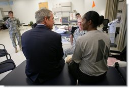 President George W. Bush speaks with a wounded soldier during his visit Thursday, Nov. 8, 2007 to the physical therapy and training area at the Center for The Intrepid at the Brooke Army Medical Center in San Antonio, Texas. White House photo by Eric Draper
