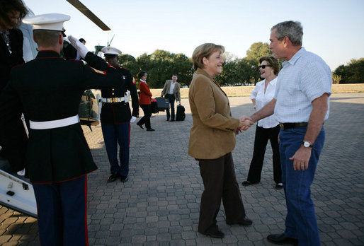 President George W. Bush and Mrs. Laura Bush welcome German Chancellor Angela Merkel and her husband Dr. Joachim Sauer as they arrive via helicopter to the Bush ranch in Crawford, Texas, Friday, Nov. 9, 2007. White House photo by Eric Draper