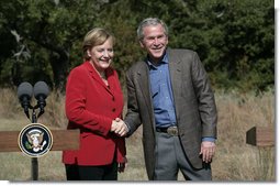 President George W. Bush and German Chancellor Angela Merkel greet each other at the end of their press conference at the Bush Ranch in Crawford, Texas, Saturday, Nov. 10, 2007. White House photo by Eric Draper