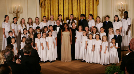 President George W. Bush and Mrs. Laura Bush join singer Melinda Doolittle, center, and members of the World Children's Choir on stage Tuesday evening, Nov. 13, 2007 in the East Room of the White House, during the social dinner in honor of the tenth anniversary of America's Promise-The Alliance for Youth. White House photo by Joyce N. Boghosian