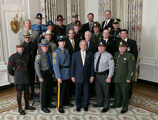President George W. Bush meets with members of the National Troopers Coalition in the State Dining Room of the White House, Wednesday, Nov. 14, 2007. Founded in 1977, the National Troopers Coalition represents the interests of state troopers and highway patrolmen and offers means to improve police services by stimulating national cooperation and elevating standards of policing. White House photo by Chris Greenberg