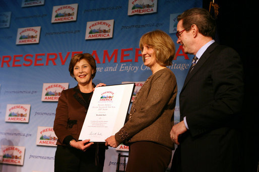 Mrs. Laura Bush presents fifth grade history teacher Maureen Festi, center, who teaches at Stafford Elementary School in Stafford, Conn., with the 2007 Preserve America National History Teacher of the Year Award at the Museum of the City of New York, Friday, Nov.16, 2007 in New York. Dr. James Basker, president of the Gilder Lehrman Institute for American History. White House photo by Shealah Craighead