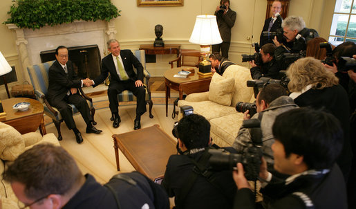 President George W. Bush and Prime Minister Yasuo Fukuda pause for White House press photographers Friday, Nov. 16, 2007, during their meeting in the Oval Office. White House photo by Eric Draper