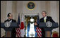 As Prime Minister Yasuo Fukuda of Japan looks on, President George W. Bush makes remarks during a joint statement Friday, Nov. 16, 2007, in the Cross Hall of the White House. Said the President, "The alliance between our two countries is rooted deeply in our strong commitments to freedom and democracy." White House photo by Chris Greenberg