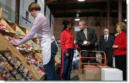 President George W. Bush talks with Linda Barnes, a volunteer, during his visit Monday, Nov. 19, 2007, to the Central Virginia Community Food Bank in Richmond, Va. With him, at right, are: Fay Lohr, Chief Executive Officer for the food bank, and Freedom Corps volunteer Paul Anderson. White House photo by Chris Greenberg