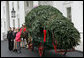 Mrs. Laura Bush welcomes the arrival of the official White House Christmas tree Monday, Nov. 26, 2007, to the North Portico of the White House. The 18-foot Fraser Fir tree, from the Mistletoe Meadows tree farm in Laurel Springs, N.C., will be on display in the Blue Room of the White House for the 2007 Christmas season. Joining Mrs. Bush, from left are, Beth Walterscheidt, president of the National Christmas Tree Association, and Joe Freeman and his wife Linda Jones of Mistletoe Meadow tree farm in Laurel Springs, N.C. White House photo by Chris Greenberg