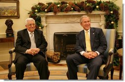 President George W. Bush and President Mahmoud Abbas of the Palestinian Authority meet in the Oval Office of the White House Monday, Nov. 26, 2007. In welcoming his fellow leader to the White House, President Bush said, "Thank you for coming, and thank you for working hard to implement a vision for a Palestinian state. We want the people in the Palestinian Territories to have hope. And we thank you for your willingness to sit down with Israel to negotiate the settlement."  White House photo by Eric Draper