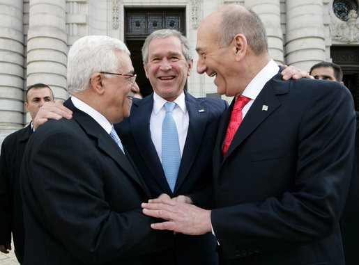 President George W. Bush congratulates President Mahmoud Abbas, left, of the Palestinian Authority, and Prime Minister Ehud Olmert of Israel following their agreement Tuesday, Nov. 27, 2007, to immediately resume long-stalled peace talks. The agreement came during the Annapolis Conference held in Annapolis, Maryland. White House photo by Chris Greenberg