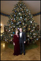 Celebrating the 2007 holiday season, President George W. Bush and Mrs. Laura Bush pose in front of the Christmas Tree in the Blue Room of the White House. White House photo by Eric Draper