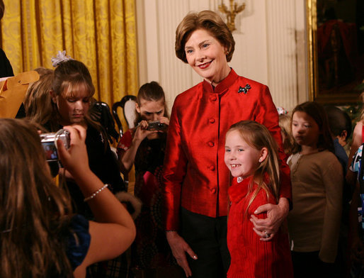 Mrs. Laura Bush poses for a photo with a young guest following the performance of the Ford's Theater cast members presentation of “A Christmas Carol,” Monday, Dec. 3, 2007, at the White House Children’s Holiday Reception. White House photo by Shealah Craighead