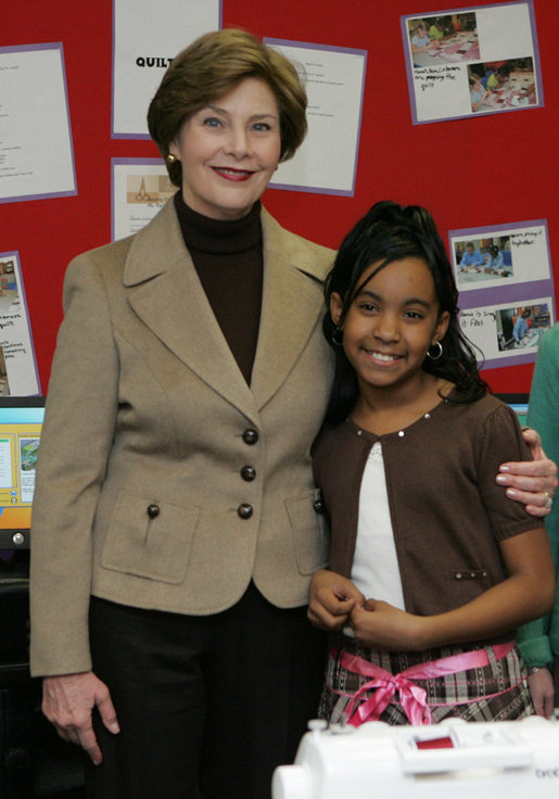 Mrs. Laura Bush embraces 10-year-old Taylor Rice, whose father is currently serving overseas in the Army Reserves, during a visit to the Learning Center at Andrews Air Force Base in Maryland, Wednesday, Dec. 5, 2007, where Mrs. Bush participated is a roundtable discussion on the special needs of military youth and families. White House photo by Joyce N. Boghosian