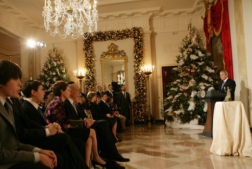 President George W. Bush delivers remarks during the Menorah lighting Monday, Dec. 10, 2007, in the Grand Foyer of the White House. Said the President, "Laura and I wish people of Jewish faith around the world a happy Hanukkah. May God bless you all." White House photo by Chris Greenberg