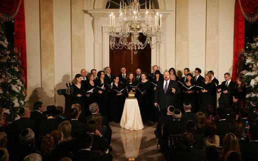 Tenor Alberto Mizrahi, the cantor at Chicago's historic Anshe Emet Synagogue, is joined by the Zamir Chorale as they entertain during the lighting of the Menorah Monday, Dec. 10, 2007, in the Grand Foyer of the White House. White House photo by Joyce N. Boghosian