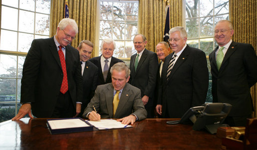 President George W. Bush signs into law H.R. 1429, the Improving Head Start for School Readiness Act of 2007, in the Oval Office Wednesday, Dec. 12, 2007. Members of Congress looking on are, from left: California Rep. George Miller; Michigan Rep. Dale Kildee; Sen. Ted Kennedy, D-Mass.; Delaware Rep. Mike Castle; Sen. Lamar Alexander, R-Tenn.; Sen. Mike Enzi, R-Wyo., and California Rep. Buck McKeon. White House photo by Chris Greenberg