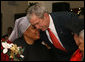 President George W. Bush shares a moment with a staff member at the Little Sisters of the Poor in Washington, D.C., Tuesday, Dec. 18, 2007, during his visit with Mrs. Laura Bush to the facility that provides nursing and assisted-living services to elderly people of lesser means. White House photo by Shealah Craighead
