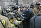 President George W. Bush shakes the hands of Washington, D.C. firefighters Wednesday, Dec. 19, 2007, after they battled a morning blaze at the Eisenhower Executive Office Building on the White House complex. White House photo by Chris Greenberg