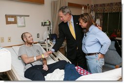 President George W. Bush visits U.S. Navy Hospital Corpsman Christopher Braley and his mother, Debra Braley, of Manteca, Calif., at the National Naval Medical Center in Bethesda, Md., Wednesday, Dec. 19, 2007. Braley is recovering from injuries sustained in Operation Iraqi Freedom. White House photo by Joyce N. Boghosian