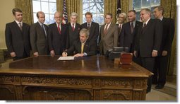 President George W. Bush signs into law H.R. 4118, the Prevent Taxation of Payments to Virginia Tech Victims and Families Act, Wednesday, Dec. 19, 2007, in the Oval Office of the White House. White House photo by Eric Draper