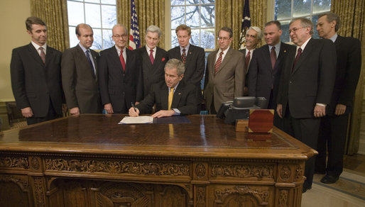 President George W. Bush signs into law H.R. 4118, the Prevent Taxation of Payments to Virginia Tech Victims and Families Act, Wednesday, Dec. 19, 2007, in the Oval Office of the White House. White House photo by Eric Draper