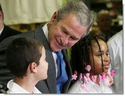 President George W. Bush talks with sixth grade student Mariano Ramos, 11, left, and seventh grader Amber McCarthy, 12, Monday, Jan. 7, 2008, during a visit to the Horace Greeley Elementary School in Chicago. White House photo by Joyce N. Boghosian