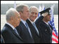 President George W. Bush elicits a smile from Israel’s Prime Minister Ehud Olmert, right, as they join Israeli President Shimon Peres for arrival ceremonies Wednesday, Jan. 9, 2008, at Ben Gurion International Airport in Tel Aviv. White House photo by Eric Draper