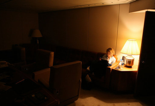 In the wee hours of the morning Wednesday, Jan. 9, 2008, White House Press Secretary Dana Perino reads through briefings aboard Air Force One. White House photo by Eric Draper