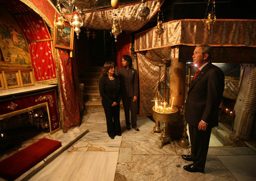 President George W. Bush pauses after lighting a candle in the Cave of the Nativity marking the birthplace of Jesus Christ during his visit to the Church of Nativity Thursday, Jan. 10, 2008, in Bethlehem. With him is Secretary of State Condoleezza Rice and Khouloud Daibes, Minister of Tourism. White House photo by Eric Draper