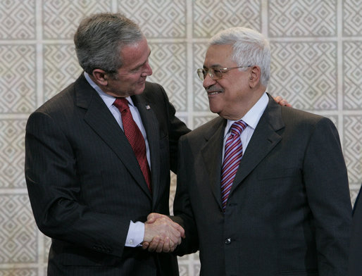 President George W. Bush and President Mahmoud Abbas exchange handshakes Thursday, Jan. 10, 2008, after a joint press availability at Muqata, the headquarters of the Palestinian Authority, in Ramallah. White House photo by Chris Greenberg