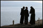 President George W. Bush is accompanied by two friars as he views the Sea of Galilee Friday, Jan. 11, 2008, during his visit to Capernaum before leaving Israel. According to sources, the location was that where Jesus walked upon the water. White House photo by Eric Draper