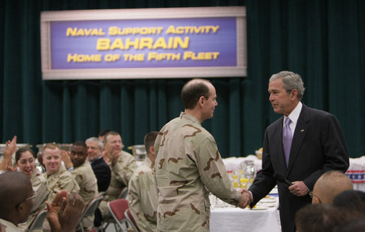 President George W. Bush shakes hands with Vice Admiral Kevin Cosgriff, Commander of the U.S. Naval Forces Central Command, during breakfast Sunday, Jan. 13, 2008, with military personnel and coalition forces at the U.S. Naval Forces Central Command in Manama, Bahrain. White House photo by Eric Draper