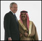 President George W. Bush smiles as he stands with King Hamad Bin Isa Al-Khalifa as they view the honor guard Saturday, Jan. 12, 2008, during arrival ceremonies in Manama, Bahrain. White House photo by Chris Greenberg