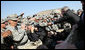 Troops reach out for President George W. Bush as he leaves the stage after delivering remarks to military personnel and coalition forces at Camp Arifjan before departing Kuwait Saturday, Jan. 12, 2008, for Bahrain. White House photo by Eric Draper