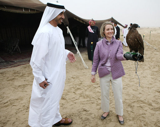 As Sheikh Abdullah bin Zayed Al Nahyan, United Arab Emirates Minister of Foreign Affairs looks on, White House Press Secretary Dana Perino holds a falcon Sunday, Jan. 13, 2008, during a dinner in the desert near Abu Dhabi. White House photo by Eric Draper