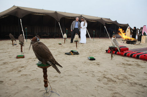 President George W. Bush and Crown Prince Sheikh Mohammed bin Zayed Al Nayhan look at falcons during their dinner Sunday, Jan. 13, 2008, in the desert near Abu Dhabi. White House photo by Eric Draper