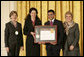Mrs. Laura Bush along with Dr. Anne Radice, the Director of the Institute of Museum and Library Services, right, presents a 2007 National Awards for Museum and Library Services awards to both Nancy Stueber, Director, and Priyam Shah, Community Representative of the Oregon Museum of Science & Industry, Portland, OR, during a ceremony in the East Room at the White House Monday, January 14, 2008. "Regular visitors to OMSI can touch a tornado, uncover a fossil, experience an earthquake, visit the Northwest's largest planetarium, explore a Navy submarine, or just experiment on their own in one of eight hands-on labs." Mrs. Bush said of the Oregon Museum of Science & Industry during her remarks. White House photo by Shealah Craighead