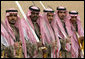 Sword dancers pose for a photograph Tuesday, Jan. 15, 2008, as they await the arrival of President George W. Bush to Al Murabba Palace in Riyadh. The President spent his last day in Saudi Arabia participating in a roundtable, visiting the King's Palace and National History Museum, and spending the evening at Al Janadriyah, the King's ranch.
