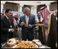 President George W. Bush and Prince Salman bin Abdul Al-Aziz, right, taste a vendor's offering Tuesday, Jan. 15, 2008, as they visited Al Murabba Palace and National History Museum in Riyadh. White House photo by Eric Draper