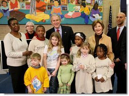 President George W. Bush and Laura Bush are joined by Washington, D.C. Mayor Adrian Fenty, right, and Ginnie Cooper, Chief Librarian for the Washington, D.C. libraries, left, posing for photos with children and staff at a reading class commemorating Martin Luther King, Jr., Day Monday, Jan. 21, 2008, at the Martin Luther King, Jr., Memorial Library. White House photo by Eric Draper