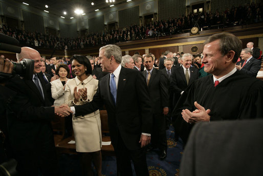 President George W. Bush shakes the hand of Secretary of Treasury Henry Paulson as he arrives on the House floor at the U.S. Capitol Monday, Jan. 28, 2008, to deliver his 2008 State of the Union address. Looking on are Secretary of State Condoleezza Rice and U.S. Supreme Court Chief Justice John Roberts. White House photo by Eric Draper