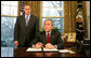 President George W. Bush, joined by Office of Management and Budget Director Jim Nussle, talks with reporters prior to signing an executive order Tuesday, Jan. 29, 2008 in the Oval Office, protecting American taxpayers from government spending on wasteful earmarks. White House photo by Eric Draper