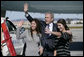 President George W. Bush waves to the friends and family of sisters Marni and Berni Barta of Los Angeles, Calif., after presenting them with the President’s Volunteer Service Award, Wednesday, Jan. 30, 2008 in Los Angeles, for their founding of the not-for-profit program Kid Flicks. The Kid Flicks program collects and donates new and used DVDs to children’s hospitals and pediatric centers across the U.S. White House photo by Eric Draper