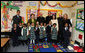 Mrs. Laura Bush accompanied by Archbishop of Washington, D.C.Donald W. Wuerl, pose for a photo with staff and students of Holy Redeemer School Wednesday, Jan. 30.2008, in Washington, D.C. White House photo by Shealah Craighead