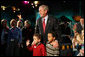 President George W. Bush pauses to talk Friday, Feb. 1, 2008, with Eli Lockhart, left, and Alex Harris, both 6 years old, at the Kaleidoscope Creative Center at Hallmark Cards, Inc., in Kansas City, Mo. White House photo by Eric Draper